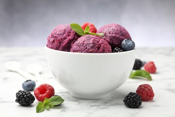 Delicious sorbet with fresh berries and mint in bowl on white marble table against grey background, closeup