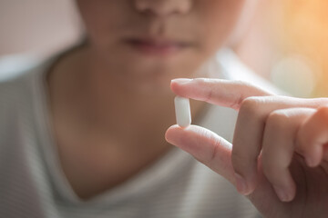 Teenager child girl, Asian youth kid having drug medicine tablet, taking medical pill for pain...