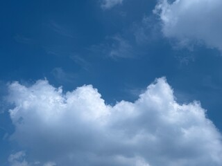 Bright Summer Blue Sky with Large Fluffy White Clouds and Clear Sunshine