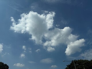 Bright Summer Blue Sky with Large Fluffy White Clouds and Clear Sunshine