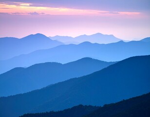 Obraz premium Fading Mountain Ridges at Sunset in Blue and Purple Hues