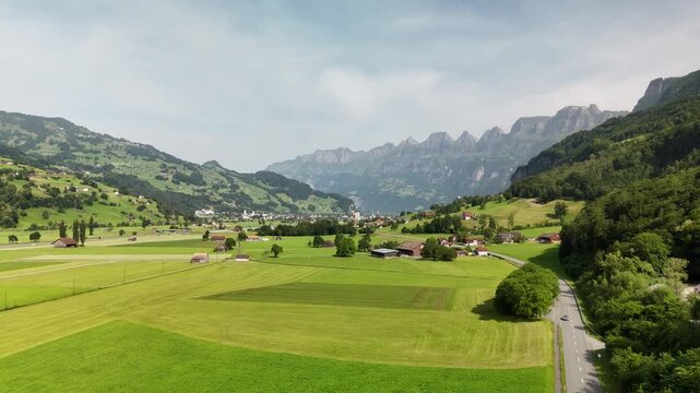 Scenic Aerial View of a Valley with Green Fields and Mountain Landscape in Switzerland near Flums, Berschis, and Walenstadt in the Canton of St. Gallen &ndash; Drone Footage