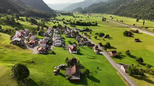 Scenic Aerial View of a Valley with Green Fields and Mountain Landscape in Switzerland near Flums, Berschis, and Walenstadt in the Canton of St. Gallen &ndash; Drone Footage