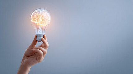 Hand Holding Light Bulb with Brain 