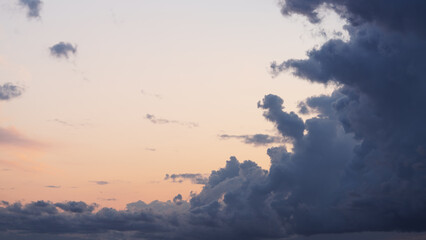 Evening clouds in the sky in summer evening with warm light