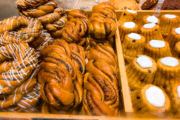 Delicious freshly baked pastries arranged in a display case at a local bakery during a busy afternoon