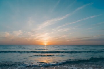 Fototapeta premium Serene Sunset Over Ocean with Calm Waves and Soft Cloudscape