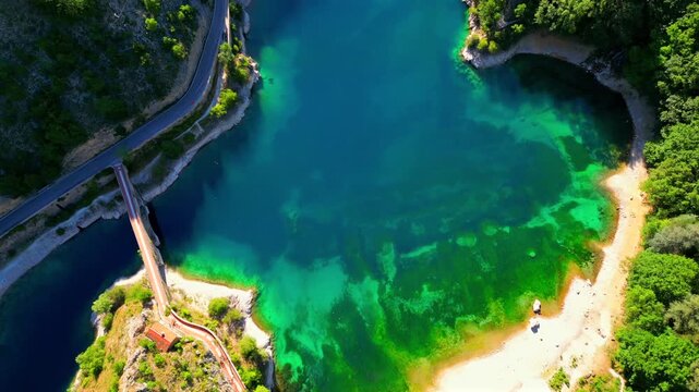Aerial drone view of Lake San Domenico in the municipality of Villalago in the province of L'Aquila, near the hermitage of San Domenico. Beautiful green hues and peace reign supreme in this place.