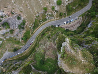Top down aerial photograph of limestone cliff formations and parked cars at Cheddar gorge in the Mendip Hills, Somerset, UK
