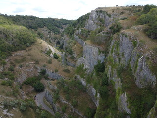 Aerial photograph of stepped limestone cliffs and clifftops at Cheddar gorge in the Mendip Hills, Somerset, UK