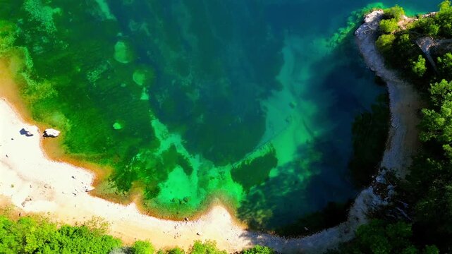 Aerial drone view of Lake San Domenico in the municipality of Villalago in the province of L'Aquila, near the hermitage of San Domenico. Beautiful green hues and peace reign supreme in this place.