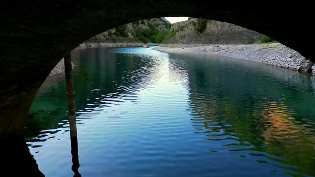 Aerial drone view of Lake San Domenico in the municipality of Villalago in the province of L'Aquila, near the hermitage of San Domenico. Beautiful green hues and peace reign supreme in this place.