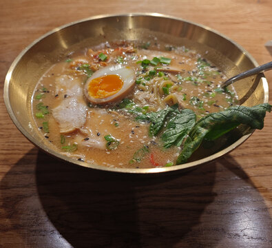 Asian ramen soup, rich chicken broth with noodles, eggs, and seaweed, miso broth-based soup, traditional pan-Asian cuisine