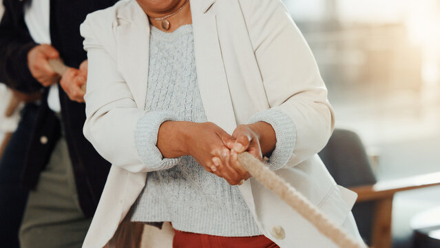 Hands, person and tug of war at office with rope pulling games, challenge and test at company. Business people, team building and group with battle, contest and synergy for competition at workplace