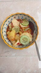 Fresh tropical fruit salad with cucumber, pineapple, jicama, and spicy chili dressing served in a colorful bowl. Perfect for summer snacks and authentic Asian cuisine lovers.