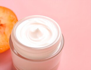 Face cream jar on soft peach pastel background