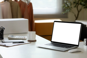 White laptop screen mockup on desk in office room