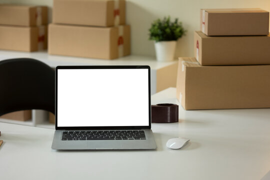 White laptop screen mockup on desk in office room