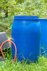 Blue plastic fertilizer tank in durian orchard, agricultural equipment for taking care of durian orchard