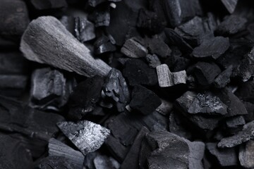 Pieces of black coals as background, top view