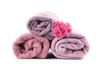 Rolled towels and flower isolated on white