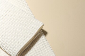 Clean waffle towels on beige background, top view. Space for text