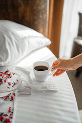 Enjoying a hot cup of coffee in a cozy bedroom setting in the morning