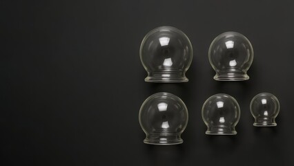 Traditional cupping therapy set on dark background. Clear glass cups offer a modern health and wellness view. Hijama, treatment according to the Sunnah.