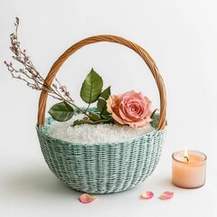 A pastel basket with a pink rose and leaves, surrounded by white stones, alongside a lit candle and rose petals, creating a calming and elegant ambiance, Self love products on white background