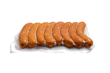 Eight sausages vacuum-packed. Eight golden-brown sausages lie close together in a transparent vacuum package. The product is presented isolated against a white background.