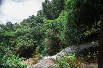 Serene Monthathan Waterfall Surrounded by Lush Greenery in Chiang Mai