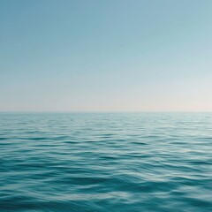 Obraz premium Calm ocean, clear sky. Vast expanse of turquoise water meets a pale blue sky