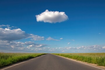 Fototapeta premium Empty road stretches into a bright blue sky