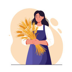 Woman holding wheat bouquet in apron with neutral background