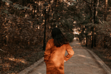Woman wearing classy brown coat, autumnal fashion cloth concept