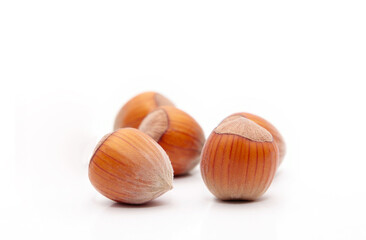 Pile of hazelnuts on a white background