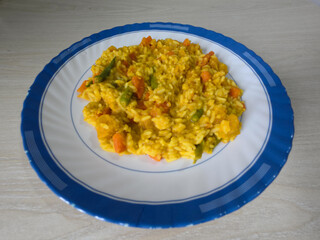 Golden Vegetable Rice on a Blue-Rimmed Plate