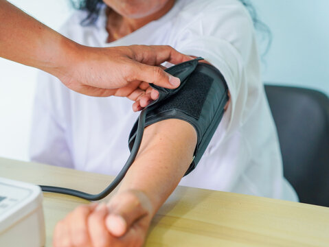 Close up hand doctor check blood pressure patient at hospital for concept healthcare. Healthy lifestyle people wellness. Senior woman home care. Person use technology help elderly people. Mental  - Powered by Adobe