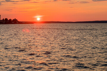 Landscape of the evening sunset against the background of the waters of the large Onega Lake.