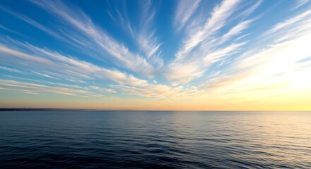 Naklejka premium Vast Ocean Under a Dramatic Sky with Wispy Clouds at Sunset water