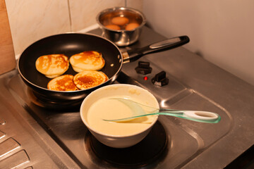 Homemade Apple Fritters Frying in a Skillet, a batter bowl and cooking process