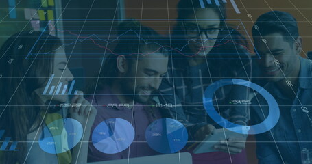Analyzing team of four professionals reviewing data on laptop, tablet at office desk, with charts