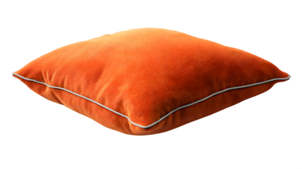 A single orange square pillow with a white trim isolated on a black background in a studio shot