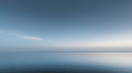 Obraz premium Calm ocean with gentle ripples under a serene blue sky stretching to the horizon.