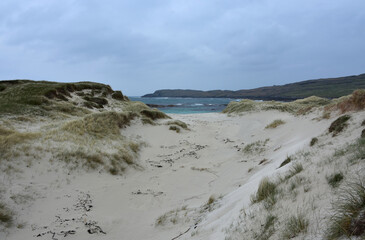 Scenic Views of Turquoise Water Through Dunes