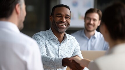 Fototapeta premium Deal of the Day: A smiling person of color extends a handshake in a professional setting, symbolizing a successful business deal. Capturing the essence of agreement and satisfaction.