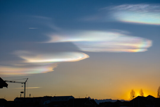 Rainbow clouds during sunset, also known as iridescent clouds, are a colorful optical phenomenon that occurs when sunlight interacts with water droplets or ice crystals in a cloud