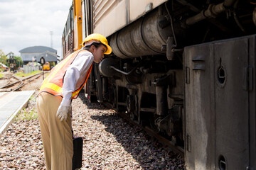 Asian young teen engineer worker work in Train station, Old locomotive service maintenance