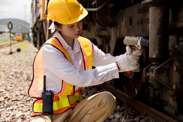 Asian young teen engineer worker work in Train station, Old locomotive service maintenance