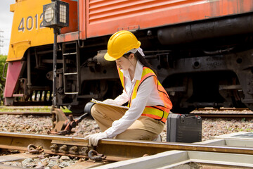Asian young teen train engineer work check inspect service maintenance old locomotive railway track